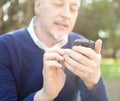 Senior man using his cell phone Royalty Free Stock Photo