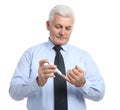 Senior man using lancet pen on white. Diabetes control