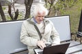 Senior man using laptop computer outdoors Royalty Free Stock Photo