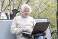 Senior man using laptop computer outdoors Royalty Free Stock Photo