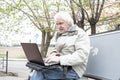 Senior man using laptop computer outdoors Royalty Free Stock Photo