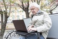 Senior man using laptop computer outdoors Royalty Free Stock Photo