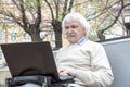 Senior man using laptop computer outdoors Royalty Free Stock Photo