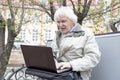 Senior man using laptop computer outdoors Royalty Free Stock Photo