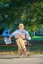 Senior man using laptop computer at rest in the park outdoors Royalty Free Stock Photo