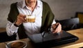 Senior man using laptop and having coffee in the bar Royalty Free Stock Photo