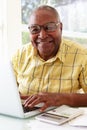 Senior Man Using Laptop At Home Royalty Free Stock Photo