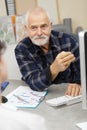 Senior man using laptop in office Royalty Free Stock Photo