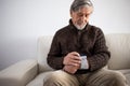 Senior man using medical device to measure blood pressure Royalty Free Stock Photo