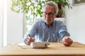 Senior man using medical device to measure blood pressure Royalty Free Stock Photo