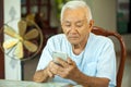 Senior man using the mobile phone at home Royalty Free Stock Photo
