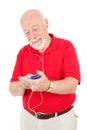 Senior Man Using MP3 Player Royalty Free Stock Photo