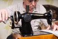 Senior Man Using Old Fashioned Sewing Machine Royalty Free Stock Photo