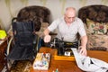 Senior Man Using Old Fashioned Sewing Machine Royalty Free Stock Photo