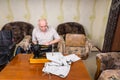 Senior Man Using Old Fashioned Sewing Machine Royalty Free Stock Photo