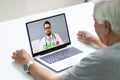 Senior Man In Videochat Or Videoconference With Doctor