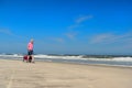 Senior man walking with cart at the beach Royalty Free Stock Photo