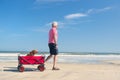 Senior man walking with dog at beach Royalty Free Stock Photo