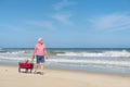 Senior man walking with dog at beach Royalty Free Stock Photo