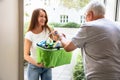 Man Offering Help To His Daughter Carrying Groceries Royalty Free Stock Photo