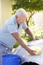 Senior Man Washing Car In Drive Royalty Free Stock Photo