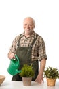 Senior man watering plants