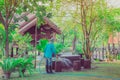 Senior man watering plants with hose and working in garden. Royalty Free Stock Photo