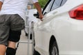 Senior man wear knee support brace on leg standing at the car parking lot, Medical and healthcare concept Royalty Free Stock Photo