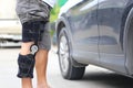 Senior man wear knee support brace on leg standing at the car parking lot, Medical and healthcare concept Royalty Free Stock Photo