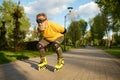 Senior man wearing funny goggles enjoying speed ride on roller skates
