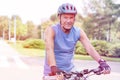 Senior man wearing helmet while riding bicycle in park Royalty Free Stock Photo