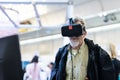 Senior man wearing virtual reality goggles watching virtual reality presentation. Royalty Free Stock Photo