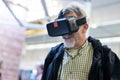 Senior man wearing virtual reality goggles watching virtual reality presentation. Royalty Free Stock Photo