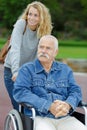 Senior man in wheelchair and daughter in park Royalty Free Stock Photo