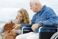 Senior man in wheelchair and daughter in park Royalty Free Stock Photo