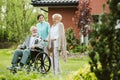 Senior man on the wheelchair in the garden of nursing home Royalty Free Stock Photo