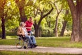 Senior man in wheelchair in the park with daughter Royalty Free Stock Photo