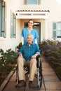 Senior man, wheelchair and portrait of nurse in healthcare support or garden walk at nursing home. Happy elderly male Royalty Free Stock Photo