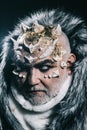 Senior man with white beard dressed like monster. Alien, demon, sorcerer makeup. Dark arts concept. Man with thorns or Royalty Free Stock Photo