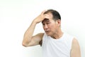 Senior man in white shirt having headache from stress and migraine while working out with white background. Royalty Free Stock Photo