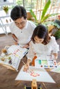 Senior man and woman couple, husband and wife, painting image together in home gallery with warm and happy circumstance. Taken