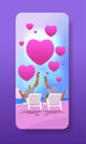 senior man woman drinking cocktails on tropical beach with pink love hearts aged couple celebrating valentines day Royalty Free Stock Photo