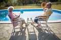 Senior man and woman enjoy on summer holiday near swimming pool Royalty Free Stock Photo