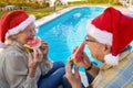 Senior man and woman enjoying in watermelon and celebrating  Christmas time Royalty Free Stock Photo