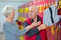 senior man and woman in fitness club locker room Royalty Free Stock Photo