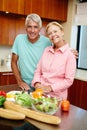 Senior man, woman and happy in cheerful, smile and cooking in kitchen at home for dinner, plans and family. Mature Royalty Free Stock Photo