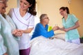 Senior man and senior woman nursing home residents assisted by medical staff of the residential facility Royalty Free Stock Photo
