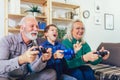 Senior man and woman play video games while their grand Royalty Free Stock Photo