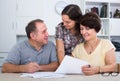 Senior man and woman signing documents