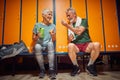 Senior man and woman sitting in dressing room taking pre workout vitamins, lovely senior couple together Royalty Free Stock Photo